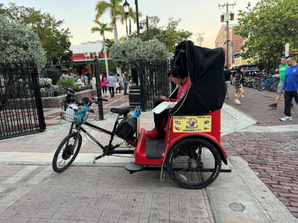 Figure 15: A tri-wheel locomotive that somewhat resembled a rickshaw at Mallory Square. Just like in Bangladesh, people use the empty spaces on the body for advertising purposes.