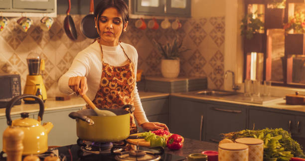 Indian Woman Cooking In Kitchen-Istock